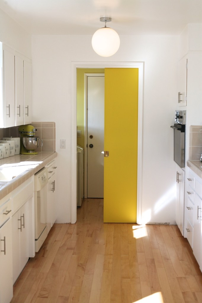 yellow pocket door kitchen mid century