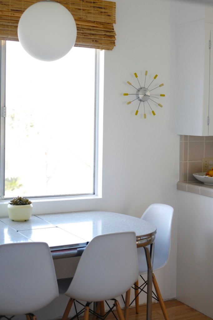 Eames chairs white kitchen formica table mid century starburst clock yellow