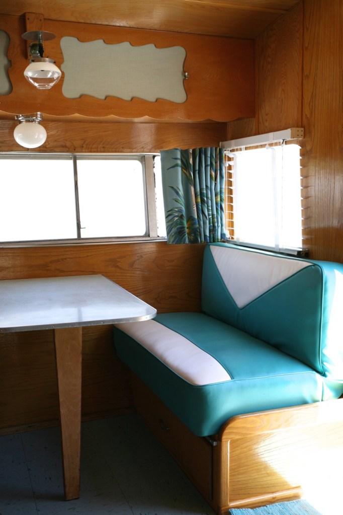 Shasta trailer vintage interior dinette vinyl upholstery barckcloth curtains blinds kitchen turquoise blue linoleum