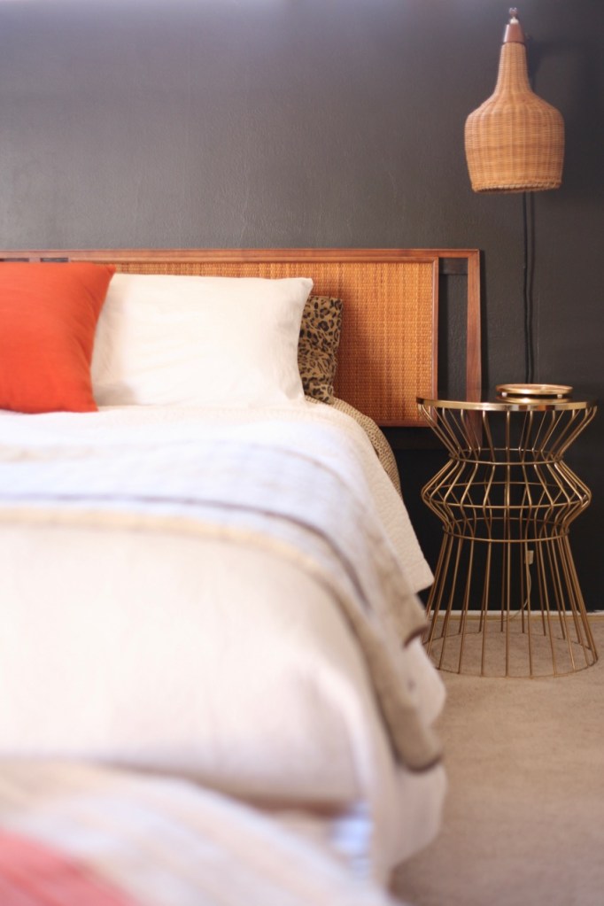 mid century danish wicker sconce cane headboard bedroom bed black wall orange brass wire table