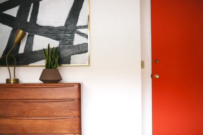 mid century modern bedroom heywood wakefield encore dresser abstract painting white walls orange door