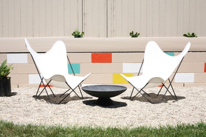 mid century yard landscape exterior painted mosaic cinderblock cinder block brick retaining wall butterfly chairs firepit colorful backyard