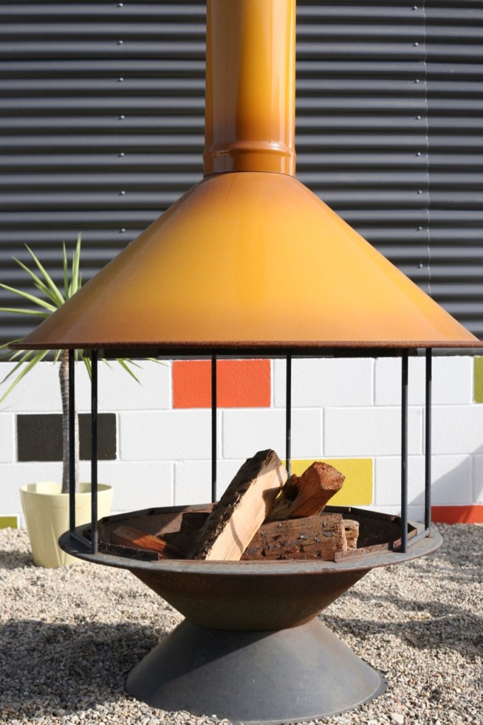vintage orange malm preway carousel fireplace in modern backyard