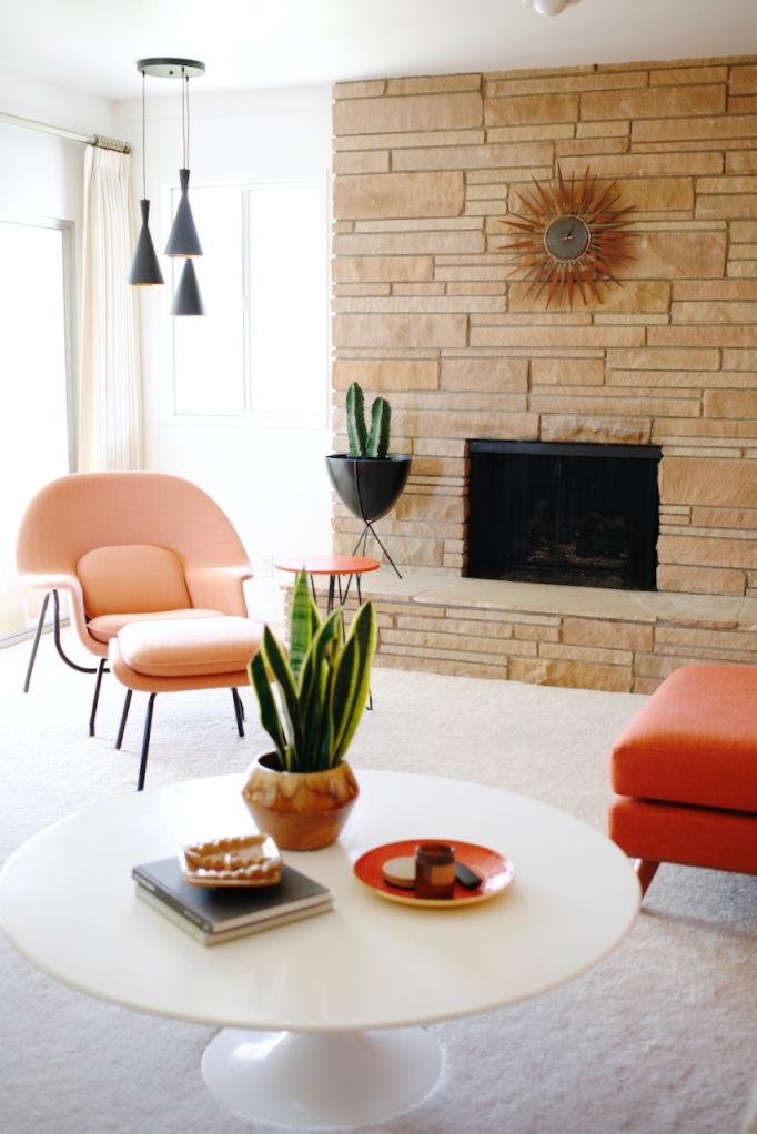 mid century family living room orange womb chair rock fireplace
