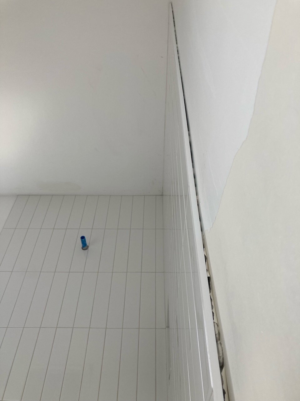 Shower tile gap wall drywall not plumb how to fix
