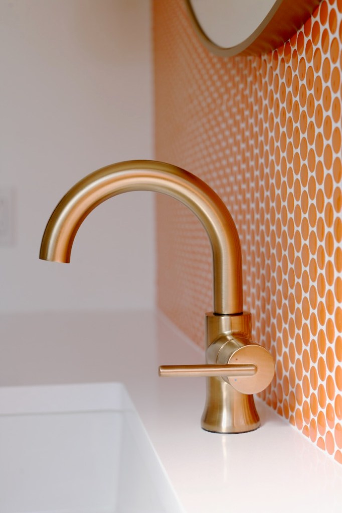Delta Trinsic faucet champagne bronze brass single handle modern bathroom mid century orange penny tile